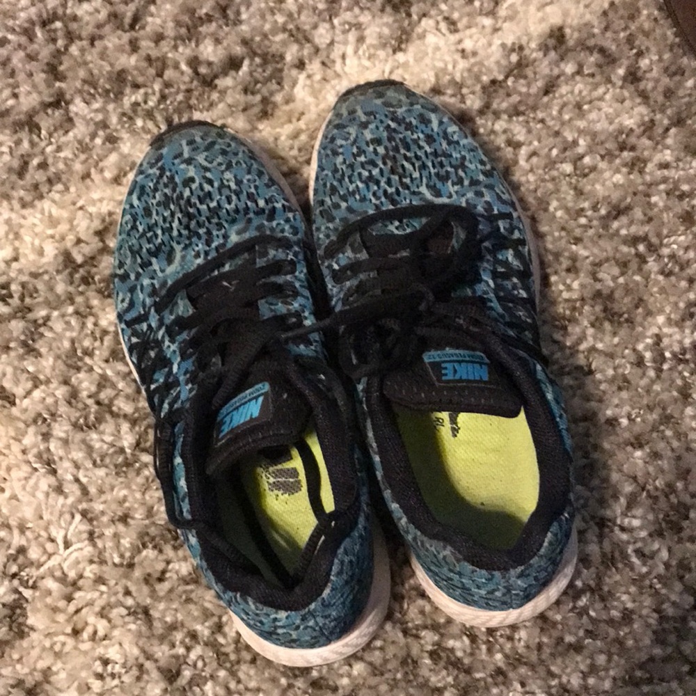 Blue cheetah print NIKE sneakers.